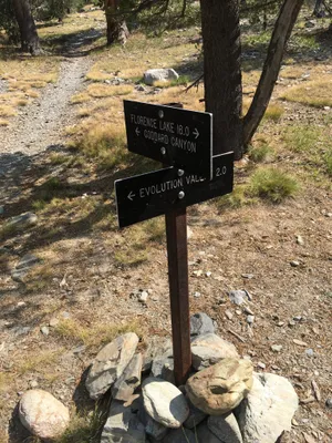Trail signs pointing in different directions: Florence Lake, Goddard Canyon, Evolution Valley.